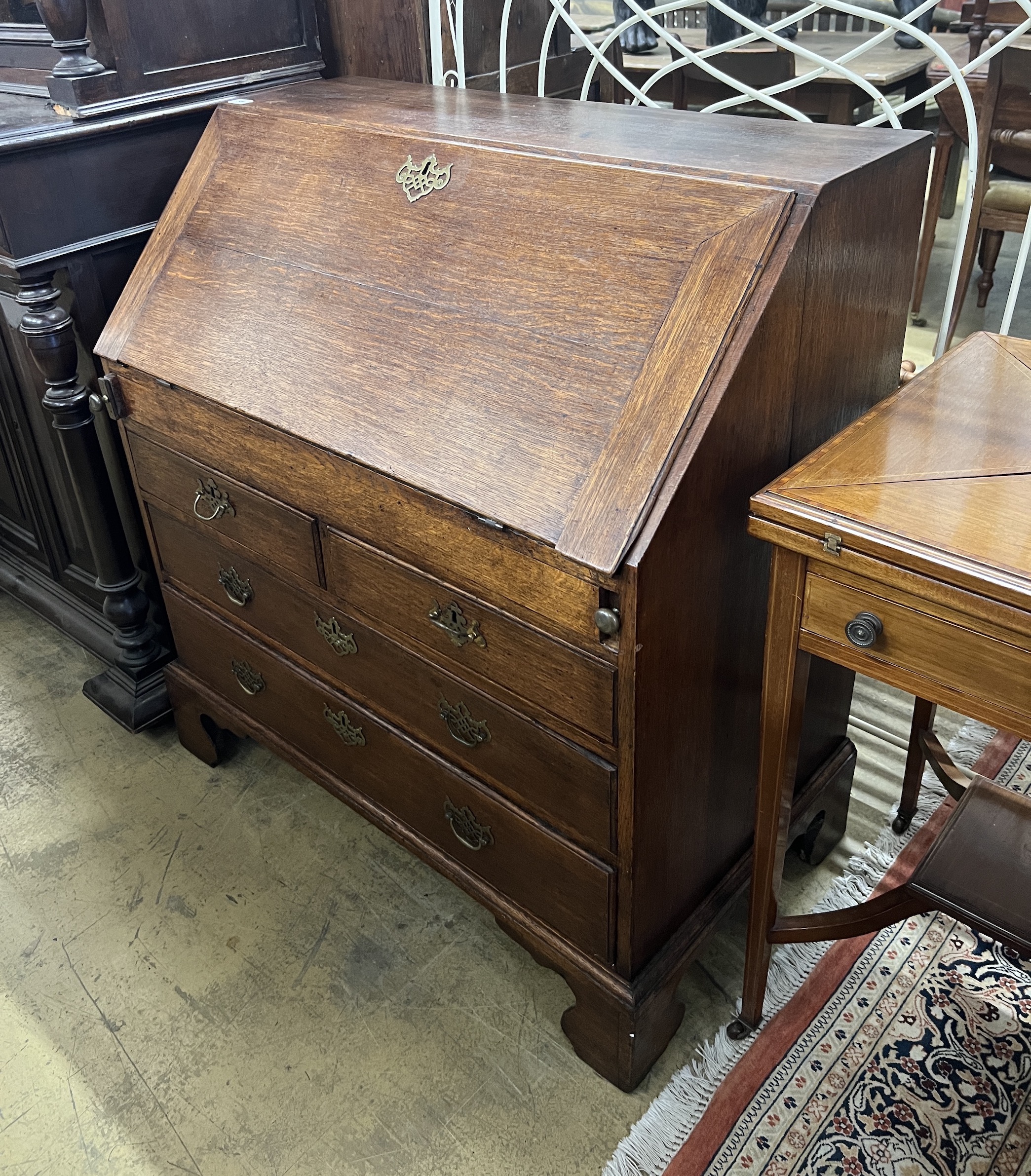 A George III oak bureau the interior with well, width 92cm, depth 53cm, height 101cm